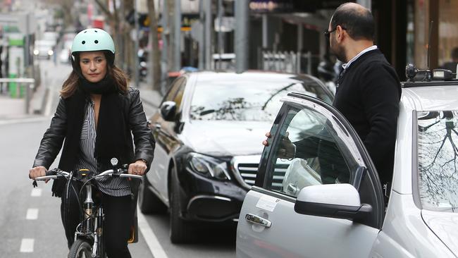 Cyclist Tatiana Marulanda, trying to avoid taxis and Ubers on Bourke St. Picture: Yuri Kouzmin