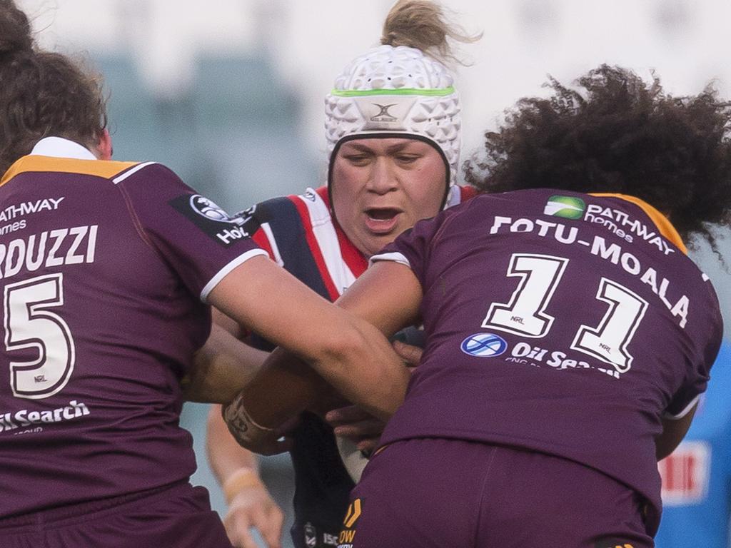 Julia Robinson (centre) of the Broncos is tackled by Holli Wheeler (left)  and Jessica Sergis (right) of the Dragons during the NRL Women's  Premiership match between the Brisbane Broncos and the St