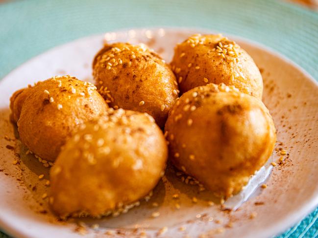 Filoxenia’s loukoumades are yeasted doughnut balls served on a platter of honey syrup and dusted with cinnamon and sesame seeds. Picture: Linda Higginson