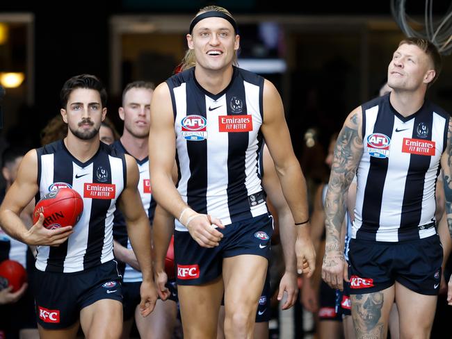‘A big rush every time you do it.’ Darcy Moore, front and centre, leading Collingwood onto the MCG. Picture: Getty Images