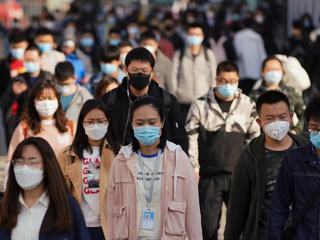 BEIJING, CHINA - APRIL 13:  Commuters wear protective masks as they exit a train at a subway station during Monday rush hour on April 13, 2020 in Beijing, China. According to the statistics of the World Health Organization, as of today, the cumulative number of confirmed cases of COVID-19 has exceeded 1.69 million, including 106,138 deaths.  (Photo by Lintao Zhang/Getty Images) *** BESTPIX ***