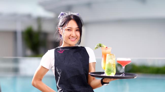 Crystalbrook Collection’s three Cairns hotels have been busy in the past 24 hours taking forward bookings into the Christmas and New Year festive season. Paper Crane restaurant bartender Yuwadee Khamsrimuang is looking forward to seeing the poolside bar buzzing with thirsty tourists again. Picture: Brendan Radke