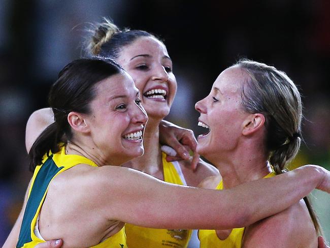 Diamonds players Madi Robinson, Kimberley Ravaillion and Renae Hallinan celebrating their 2014 Games win.