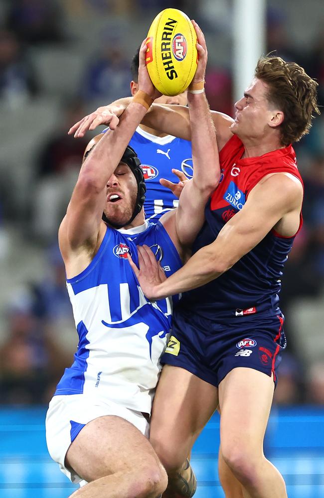 Tristan Xerri of the Kangaroos marks in front of Trent Rivers of the Demons on Saturday night. Picture: Quinn Rooney/Getty Images.