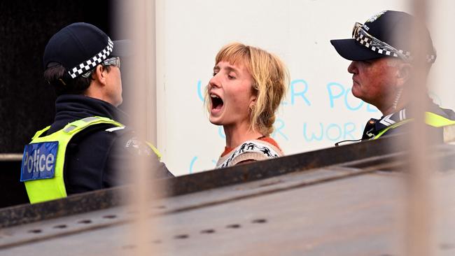 The woman could be seen yelling at police as she was taken away and is due to face the Magistrates Court later this month. Picture: AFP