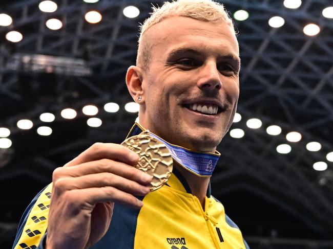 (L-R)old medallist Australia's Kyle Chalmers poses during the medals ceremony for the men's 100m freestyle swimming event during the World Aquatics Championships in Fukuoka on July 27, 2023. (Photo by MANAN VATSYAYANA / AFP)