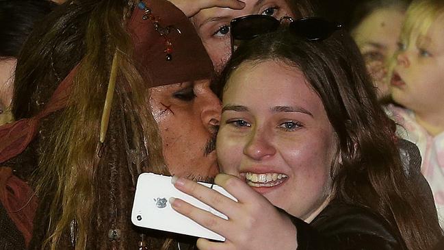 Hollywood actor Johnny Depp kisses a fan who waited several hours to see him at The Spit after filming a scene for Pirates of the Caribbean. Picture: Regi Varghese