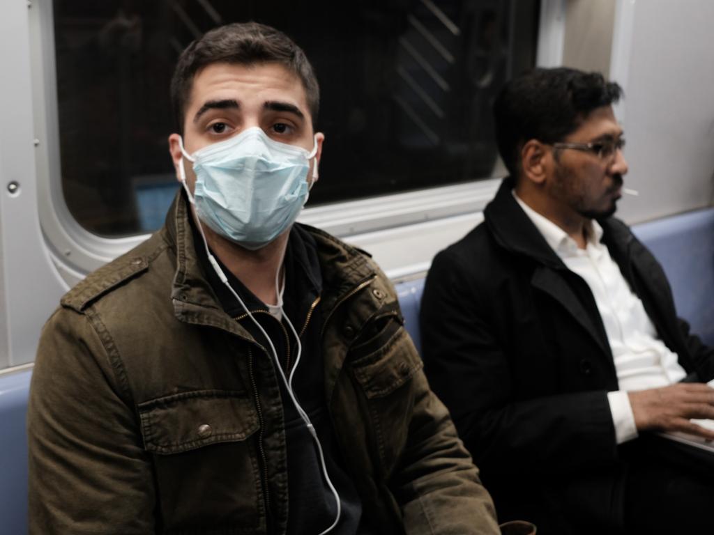 A man wears a medical mask on the subway as New York City confronts the coronavirus outbreak. Picture: Getty Images/AFP