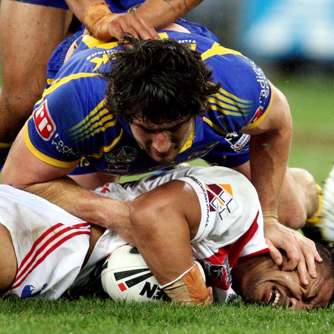 Nathan Hindmarsh making yet another tackle – with a little face massage for good measure.