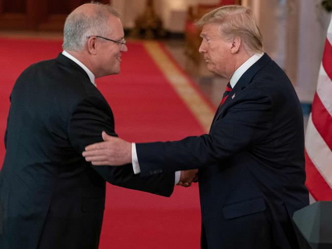 US President Donald Trump shakes hands with Australian Prime Minister Scott Morrison after calling him “titanium”. Picture: AFP