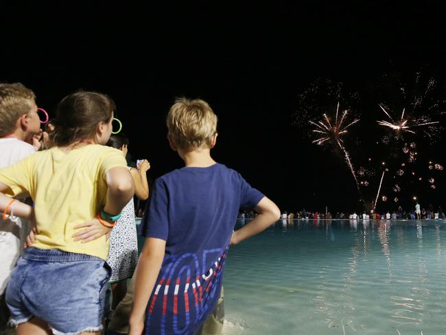 Children watch the fireworks on New Year's Eve over the Cairns Esplanade lagoon. Picture: Brendan Radke