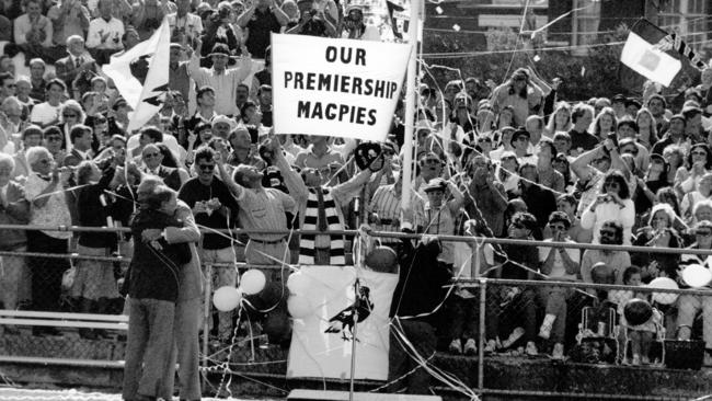 Collingwood's 1990 premiership flag is raised at Victoria Park.