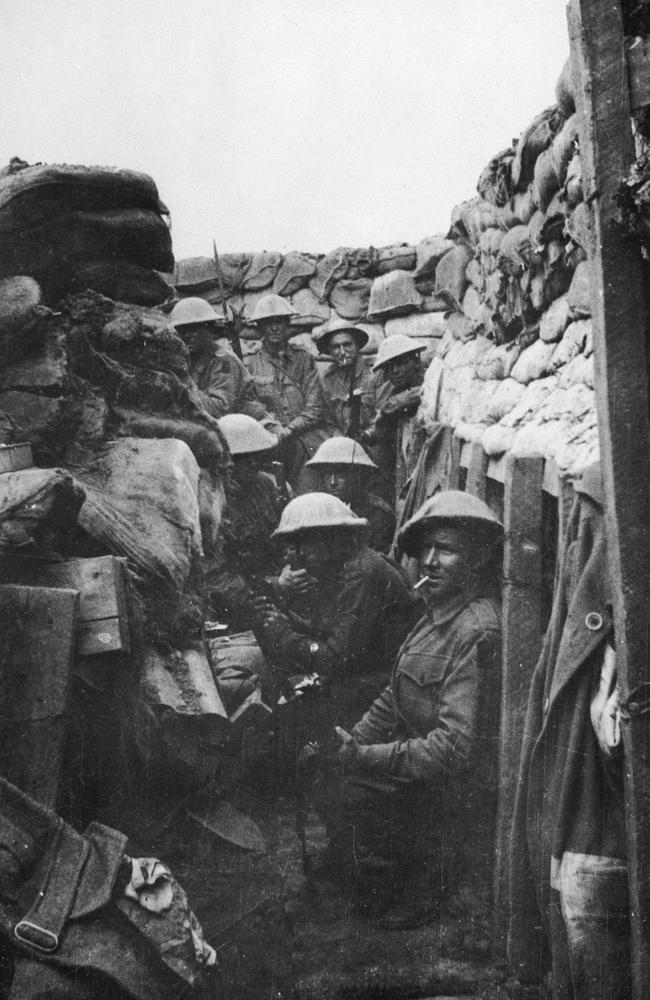 Calm before the storm on a dark day … men of the 53rd Battalion, waiting to join the attack at Fromelles. Only three of the men shown here came out of the action alive, and those three were wounded. Picture: The Australian War Memorial.