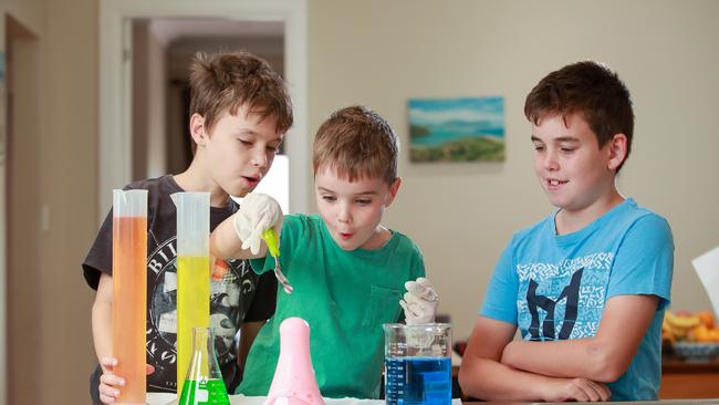 Owen, 10, Ethan, 7, Arran Storie, 12, at home doing science experiments. Picture: Justin Lloyd