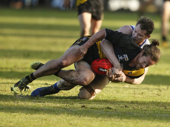 Seaford’s Andrew Teakel is wrapped up by Somerville’s Rowan Hogenbirk. Picture: Valeriu Campan