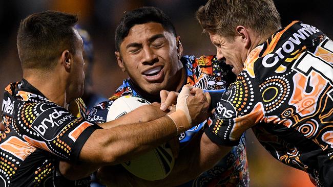 Jason Taumalolo gets crunched by Luke Brooks and Chris Lawrence. (AAP Image/Dan Himbrechts)