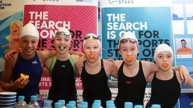 Dolphins Lucy Fuccenecco, Sam Hohn, Sophie Young, Jordan Meddings and Zoe McIntosh refuelling at Friday night’s swim meet. Pictures: Timothy Clapin