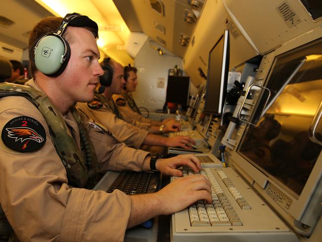 Fighting ISIS ... Flight Lieutenant Daniel White, a senior systems control officer in the Royal Australian Air Force, prepares for a mission on a E-7A Wedgetail aircraft over the Middle East.