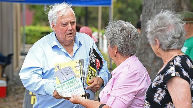 Clive Palmer handing out how to vote cards at a pre poll at Pumicestone, north of Brisbane. Picture: Lyndon Mechielsen