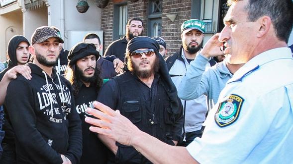 Khaled Sharrouf (in sunglasses) and Mohamed Elomar (left of Sharrouf, with full beard) at a riot in Sydney.