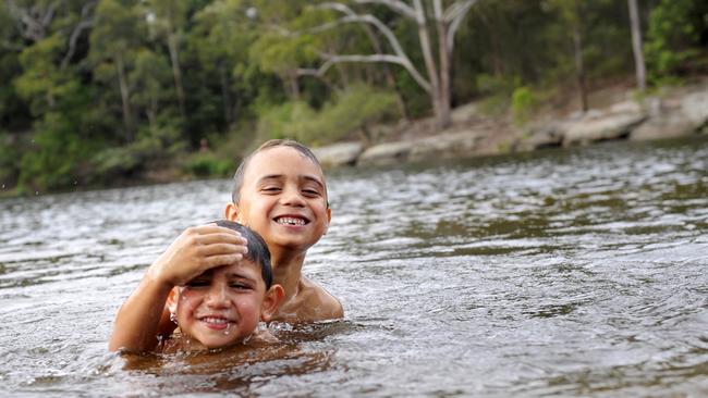 Swimmers cooling off at Parramatta Lake during the hot weather. If there are no swimmers, pic of the reserve, ropes hanging off trees etc. Pics to go with story about making the river swimmable again.