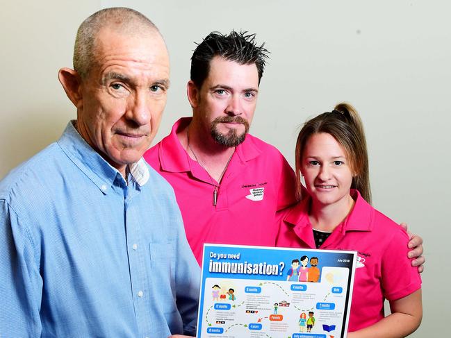 CDC community physician Charles Douglas holds the new immunization poster with parents Ash and Sally Lawrence who have been strong advocates of the Meningococcal B vaccine after losing their young daughter Skylar. Picture: Justin Kennedy