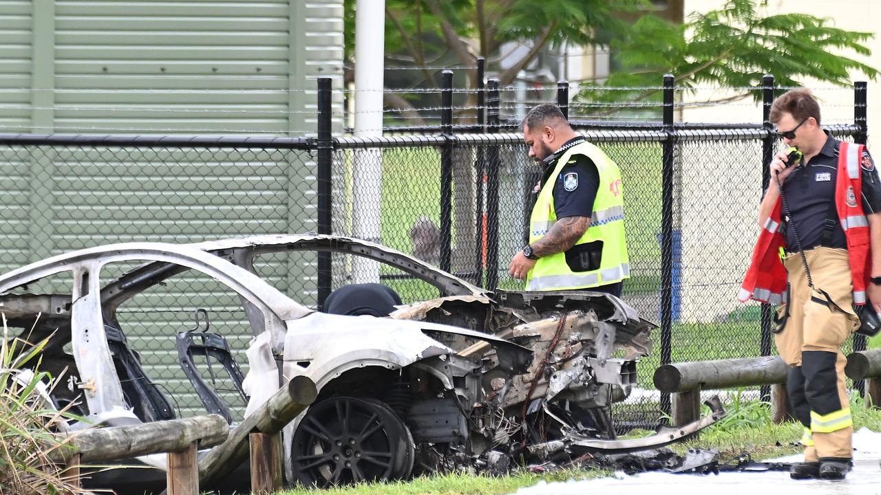 The remains of the Tesla with emergency services personnel at the scene. Picture: John Gass