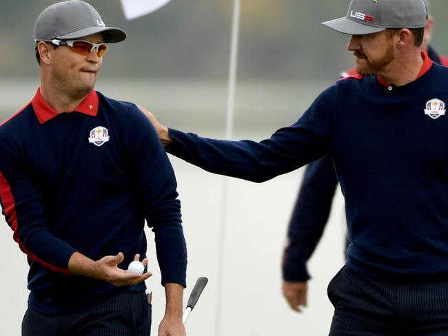 Zach Johnson and Jimmy Walker of the United States react on the seventh green during morning foursome matches of the 2016 Ryder Cup. Picture: Getty