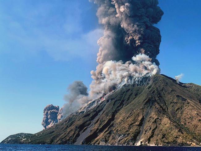 Smoke billows from the volcano on the Italian island of Stromboli, Wednesday, July 3, 2019. The news agency ANSA says that some 30 tourists jumped into the sea out of fear after a series of volcano erupted on the Sicilian island of Stromboli. Civil protection authorities said a hiker was confirmed killed by the eruptions Wednesday. (ANSA VIA AP)