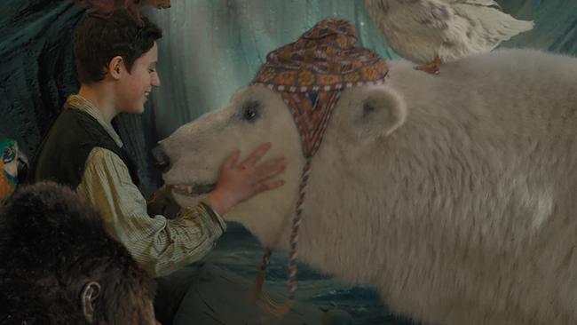 John Cena voices the positive polar bear, Yoshi, pictured with actor Harry Collett in the live action version of Dolittle.