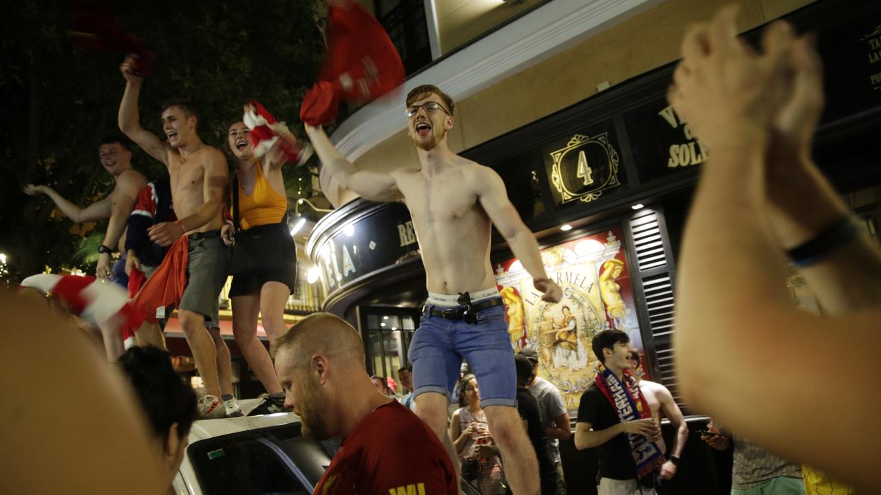 Liverpool supporters celebrate outside a pub