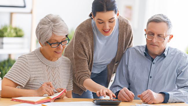 Family sitting at the desk with a paper receipt are calculating expenses, managing the family budget. Bank of Mum and Dad generic money