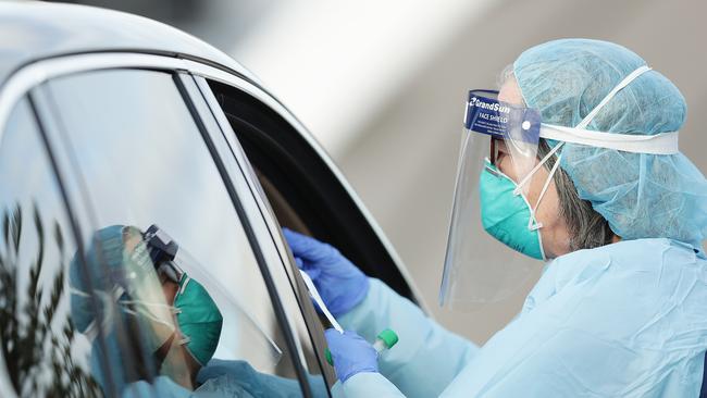 A medical professionals conducts a nasal swab test. Picture: Mark Metcalfe/Getty Images