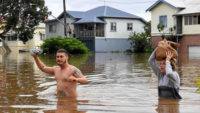 Residents wade through rising floodwaters as they leave their home in central Lismore, New South Wales, Friday, March 31, 2017. The Wilsons River breached its banks early morning flooding the far-northern NSW town. (AAP Image/Dave Hunt) NO ARCHIVING. Picture: DAVE HUNT