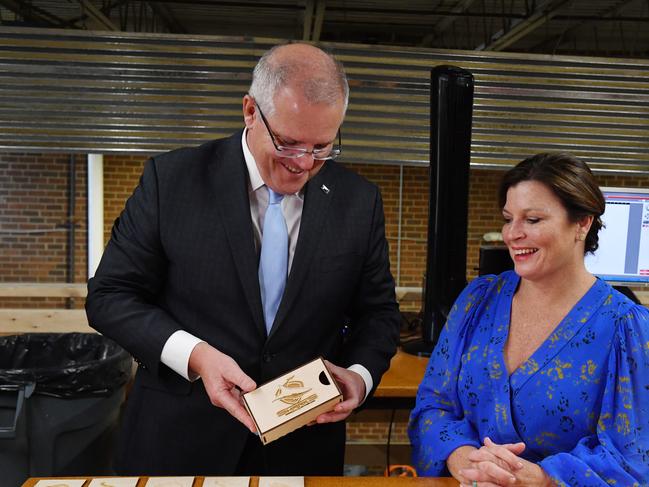 Australia's Prime Minister Scott Morrison is presented with a woodcuts boxes at the Bunker Lab program in Alexandria in Washington DC. Picture: AAP