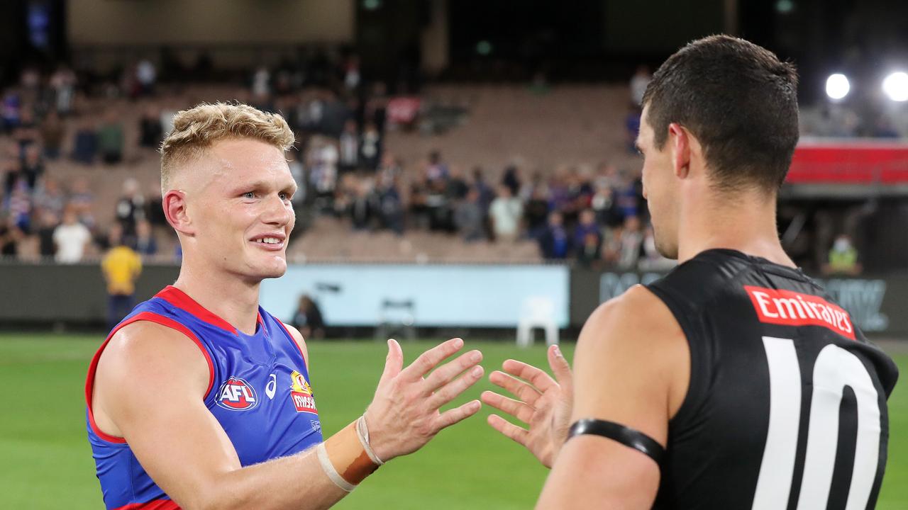 Adam Treloar shakes hands with his former skipper Scott Pendlebury post-game. Picture: Michael Klein