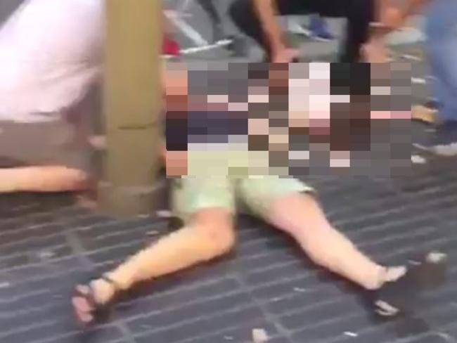 The shocking vision shows people tending to bodies on the pavement.