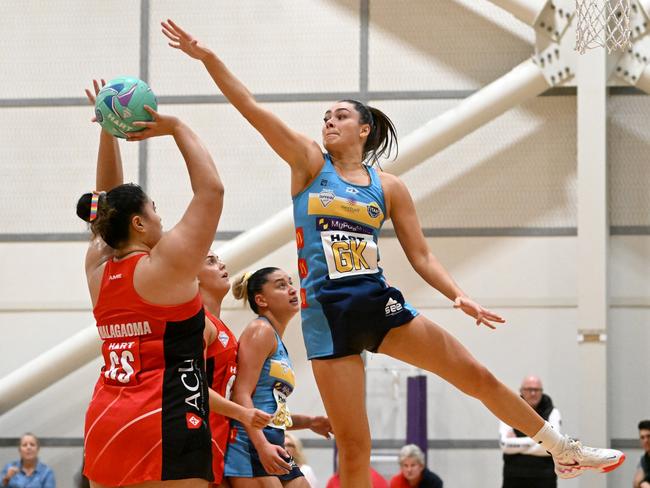 Jess Milne of the Titans defends over Cougars goal shooterLarika Malagaoma. Picture: Chloe Davis