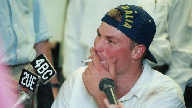 Shane Warne smoking a cigarette during a radio interview during the First Test against Pakistan at The Gabba in Brisbane in 1995.