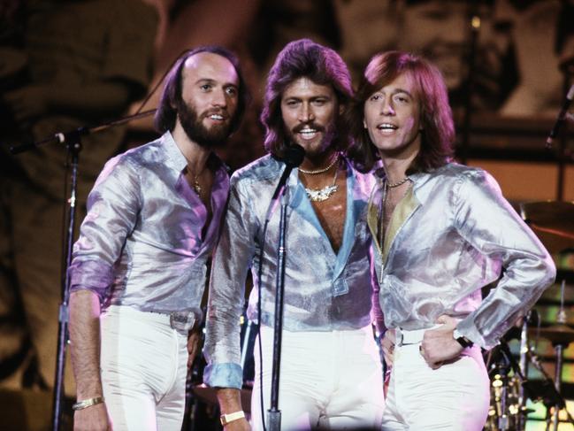 Pop vocal trio the Bee Gees performing at the Music for UNICEF Concert at the United Nations General Assembly in New York City, January 1979. Left to right: Maurice (1949 - 2003), Barry, and Robin Gibb. (Photo by Michael Putland/Getty Images)