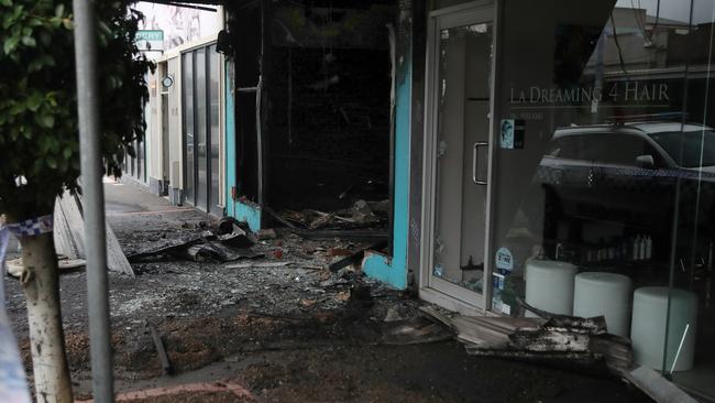 The fire threatened nearby businesses, including a hair salon. Picture: David Crosling