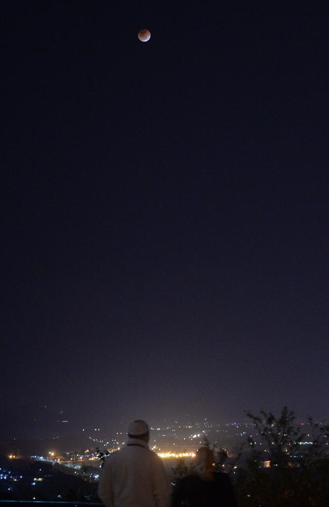 Residents of the Pakistani port city of Karachi watch the moon during the lunar eclipse. Picture: AFP