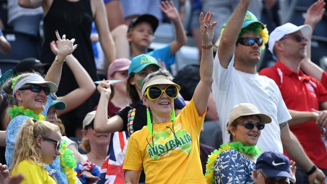 Supporters cheer before the swimming men's 200m freestyle qualifications during the 2018 Gold Coast Commonwealth Games at the Optus Aquatic Centre in the Gold Coast on April 6, 2018 / AFP PHOTO / Anthony WALLACE