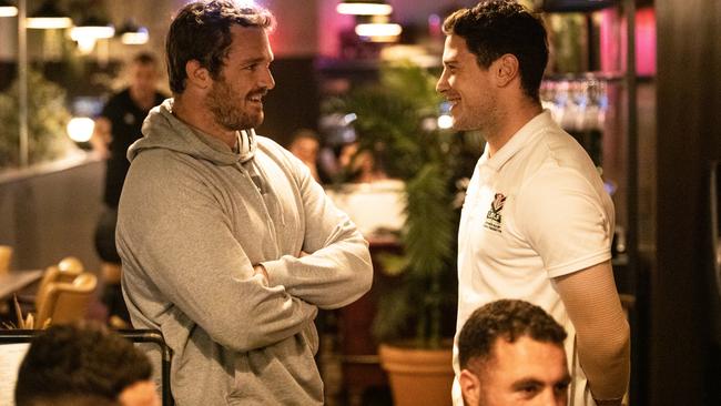 Argentina rugby hooker Julian Montoya and Lebanon rugby league halfback Mitchell Moses chat during dinner between the two teams in Manchester.