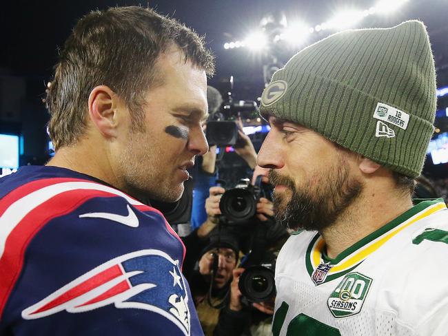 FOXBOROUGH, MA - NOVEMBER 04: Tom Brady #12 of the New England Patriots talks with Aaron Rodgers #12 of the Green Bay Packers after the Patriots defeated the Packers 31-17 at Gillette Stadium on November 4, 2018 in Foxborough, Massachusetts.   Maddie Meyer/Getty Images/AFP == FOR NEWSPAPERS, INTERNET, TELCOS & TELEVISION USE ONLY ==