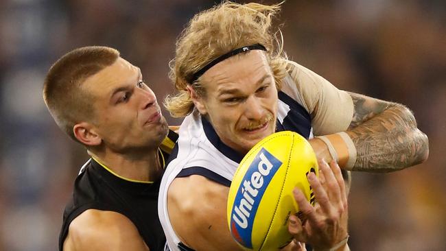 Tom Stewart gets a handball away undre pressure. Picture: AFL Photos