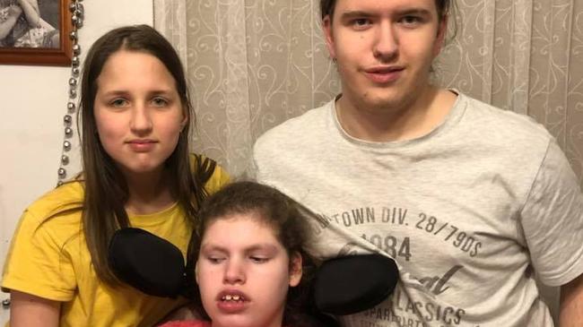 Croydon's Samuel Hausler, right, fears a school bus won't be able to pick up his disabled sister Lucy, centre, if a proposed townhouse development goes ahead in his street. Picture: Supplied.