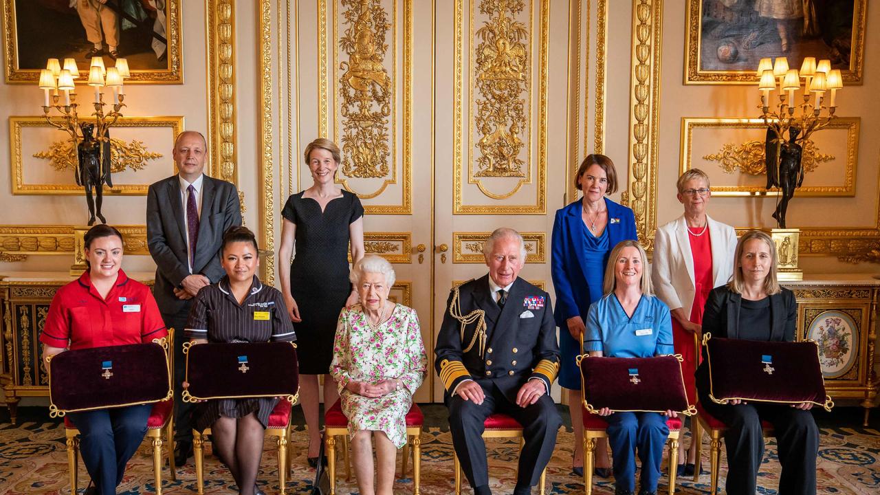 The Queen, Prince Charles, and medal recipients. Picture: AFP