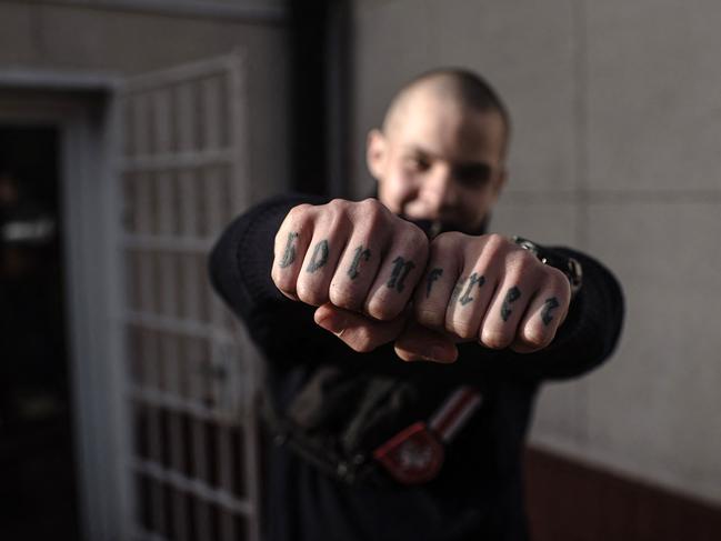 Gunko shows his 'born free' knuckle tattoos in Warsaw, Poland.