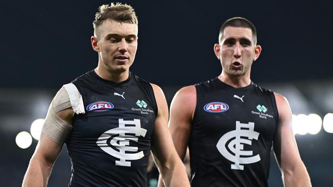 Carlton stars Patrick Cripps (left) and Jacob Weitering walk off the field dejected after the Blues’ high-scoring loss to Geelong on Saturday. Picture: Quinn Rooney / Getty Images